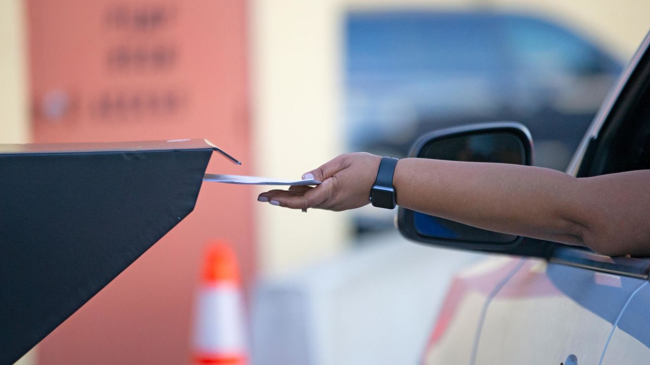 Broward County resident deposit ballots at the official dropbox during the general elections on Tuesday, Nov. 3, 2020, in Lauderhill, Florida.