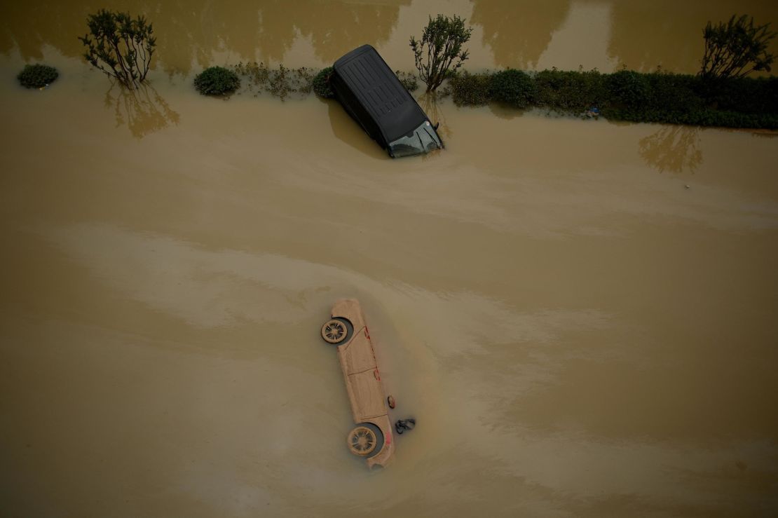 Cars sit in floodwaters following heavy rain in Zhengzhou in China's central Henan province on July 22, 2021.