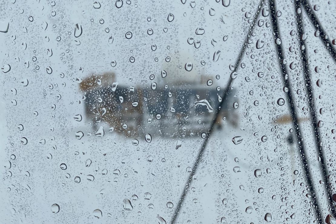 Rain droplets can be seen on a window looking out from a scientific post at the summit of Greenland in August.