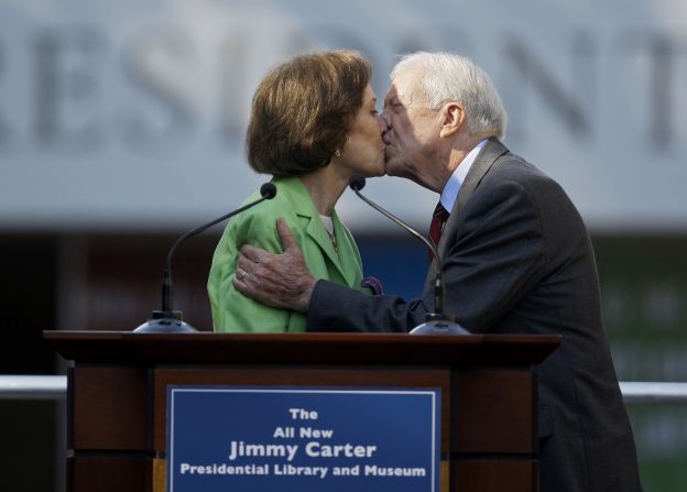 The Carters kiss in October 2009 as Rosalynn introduces her husband at the ceremony for the redesigned Carter Presidential Library in Atlanta.