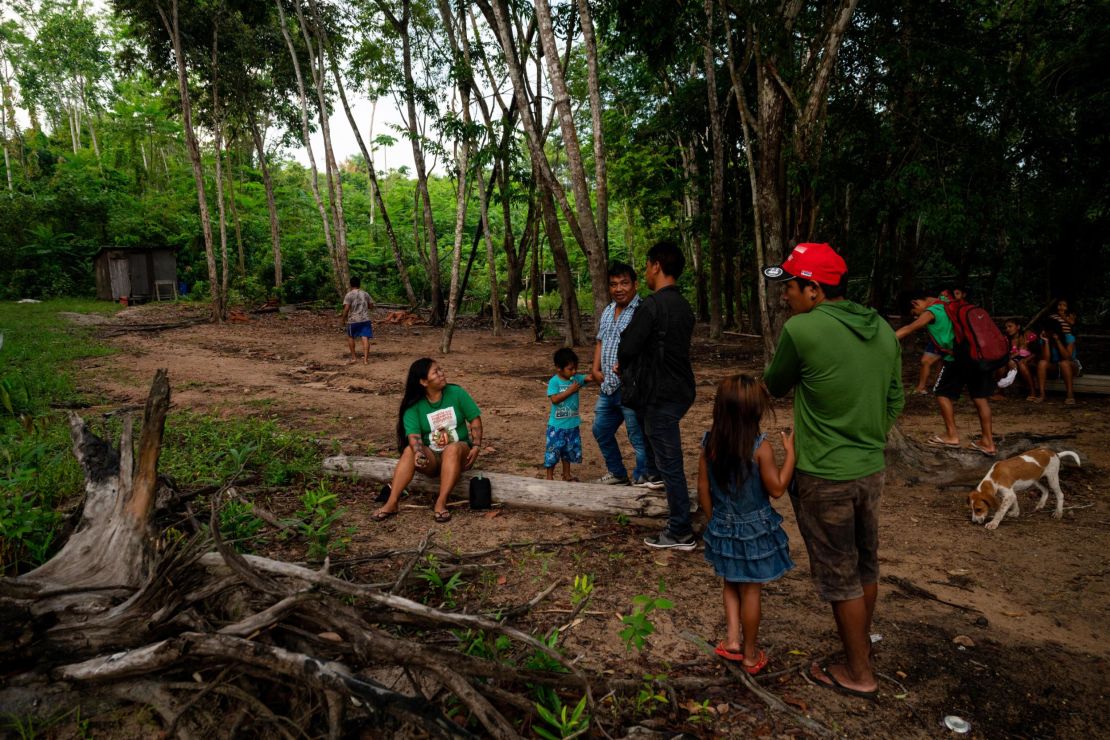 Alessandra Korap, a female leader and climate change activist from the Munduruku tribe, meets with members of the Sawré Muybu village before setting off on a patrol to monitor illegal Amazon mining.