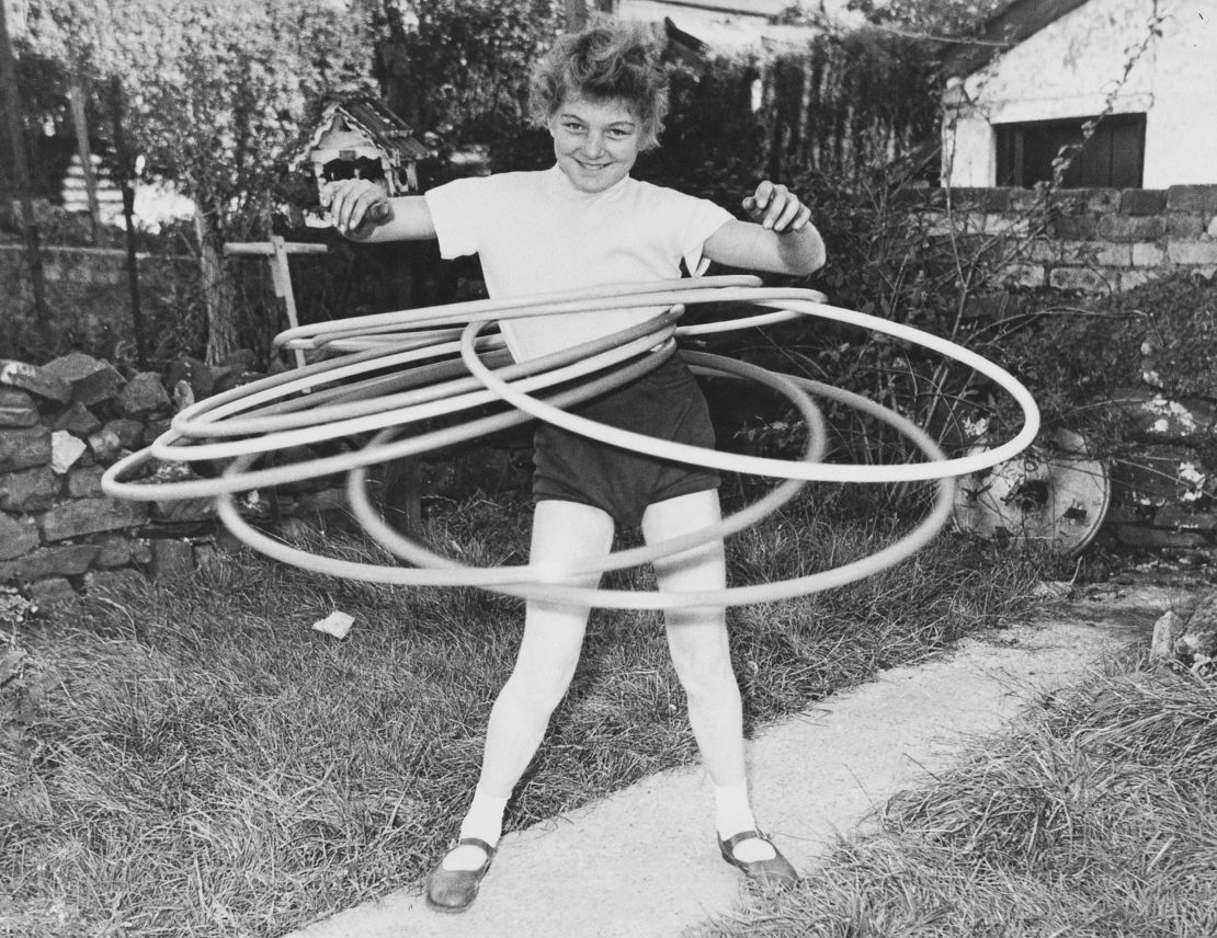 Eleven-year-old Ann Evans of Wales was the world hula hoop marathon champion, seen here twirling seven hoops simultaneously in 1958.