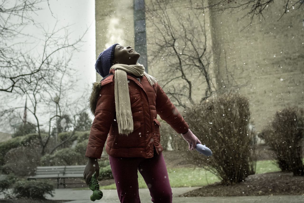 A Congolese refugee in Massachusetts, USA. She was "seeing snow for the first time," Farese said.