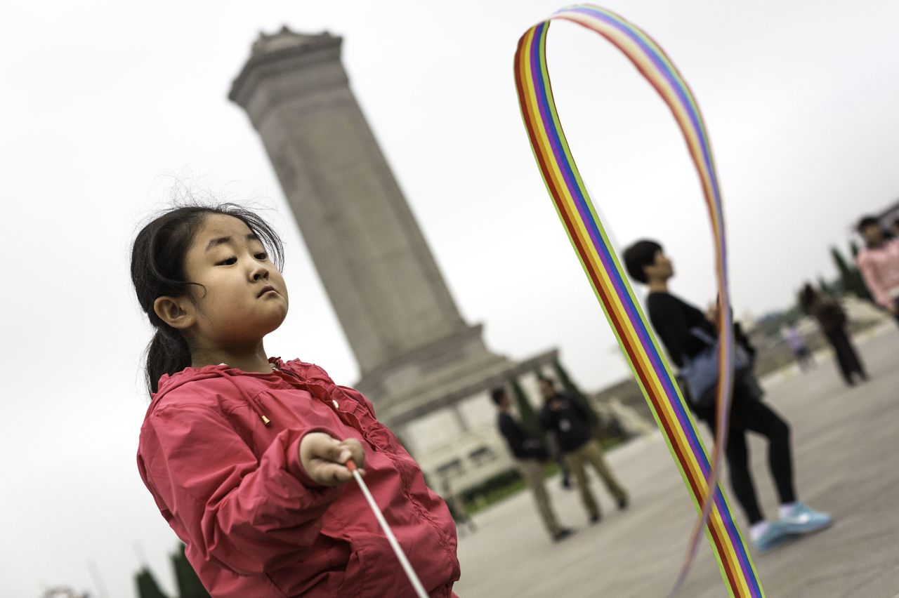 A child plays with a ribbon toy in Beijing's Tiananmen Square.