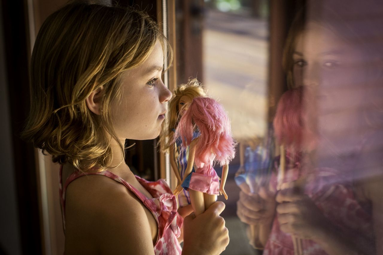 A child playing with dolls in California, USA.