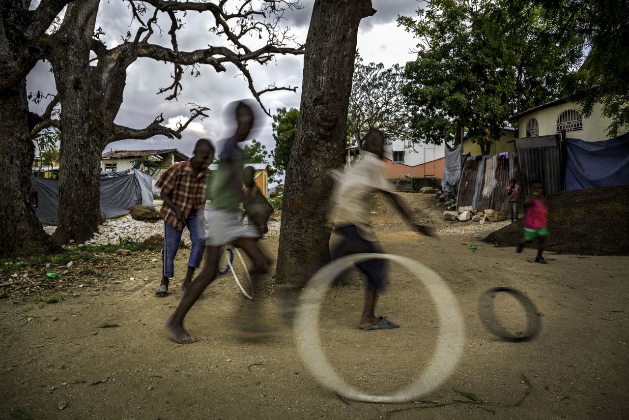 "One of the more ubiquitous games is one that, in Haiti, they called 'cercle,'" Farese said. "It's where they roll a tire and then use a wire, like coat hanger-type thing, to control it ... I've tried to do it, as an adult, just picking it up and running along the road with kids. It's super hard."