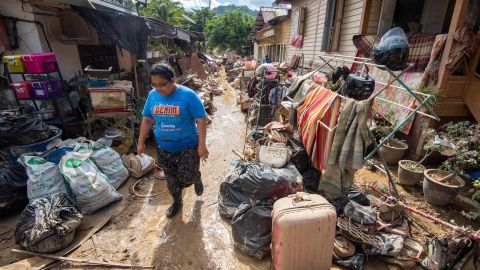 A local resident walks on a muddy path after floods hit Hulu Langat of Selangor state, Malaysia, on December 21.