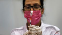 A paramedic prepares to administer the third shot of a Covid-19 vaccine on August 24, in Holon, Israel.