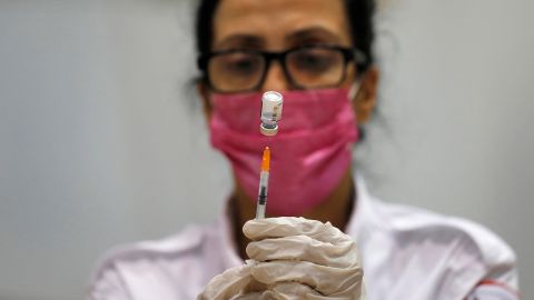 A paramedic prepares to administer the third shot of a Covid-19 vaccine on August 24, in Holon, Israel.
