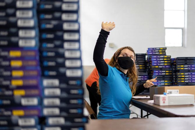 A health-care worker signals she is ready to distribute free testing kits at a site in Philadelphia.