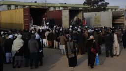 Afghan teachers line up to receive humanitarian assistance in Mazar-i-Sharif, capital of Balkh province, Afghanistan, December 15, 2021. A local trading company has provided humanitarian assistance to teachers in the northern Balkh province.