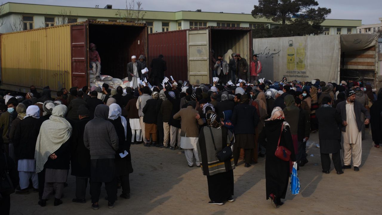 Afghan teachers line up to receive humanitarian assistance in Mazar-i-Sharif, capital of Balkh province, Afghanistan, on December 15, 2021.