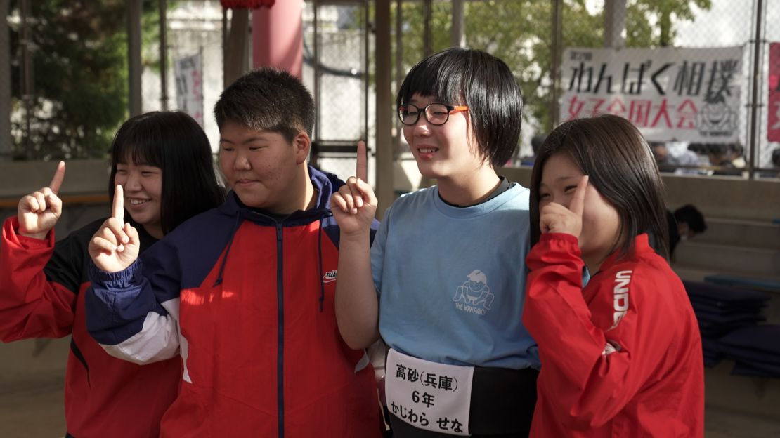 Senna Kajiwara (second from the right) poses for a photograph with her peers after winning another title.