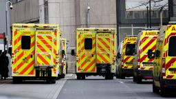 Ambulances are pictured parked outside the Royal London hospital in London on December 20, 2021. - UK Prime Minister Boris Johnson on Monday faced pressure to tighten coronavirus restrictions to prevent the spread of the Omicron variant, despite opposition to do so before Christmas. The UK reported 82,886 Covid-19 cases on Sunday as the new variant rages, with the highest number of infections in London. (Photo by Tolga Akmen / AFP) (Photo by TOLGA AKMEN/AFP via Getty Images)
