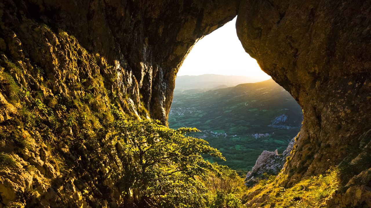 <strong>Otlica Natural Window:</strong> This naturally formed hole in the limestone karst landscape forms the perfect frame for a view of the valley.