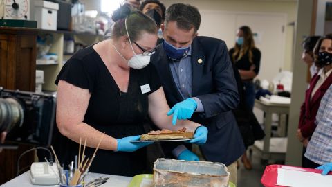 Katherine Ridgway and Virignia Gov. Ralph Northam inspect one of the items removed from the capsule.