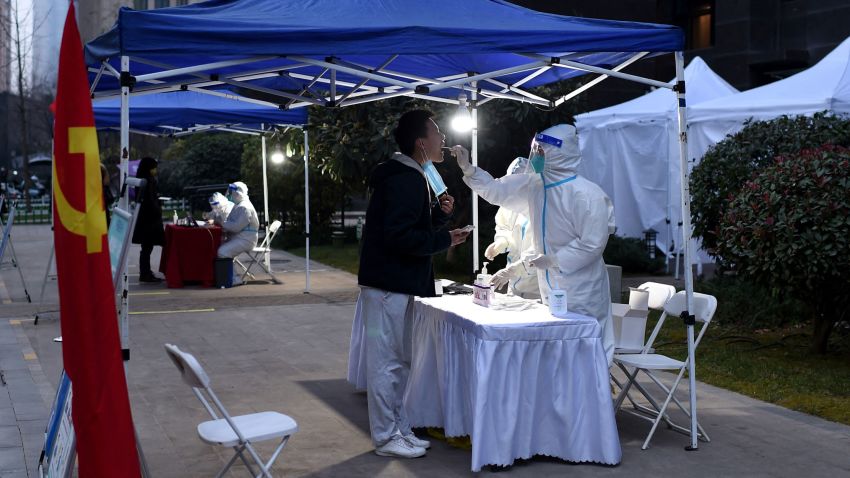 A resident undergoes a nucleic acid test for the Covid-19 coronavirus at a residental area that is under restrictions following a recent coronavirus outbreak in Xian, in China's northern Shaanxi province on December 23, 2021. - China OUT (Photo by AFP) / China OUT (Photo by STR/AFP via Getty Images)