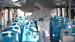 A staff member disinfects a bus in Xi'an, northwest China's Shaanxi Province, Dec. 21, 2021. (Photo by Shao Rui/Xinhua via Getty Images)