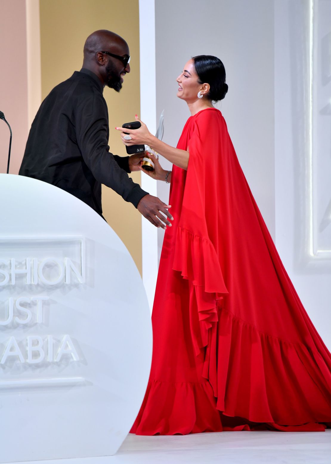 Amina Muaddi receives the Special Recognition Award for Entrepreneur of the Year from the late Virgil Abloh at the Fashion Trust Arabia Prize Gala on November 3, 2021 at the National Museum of Qatar in Doha.