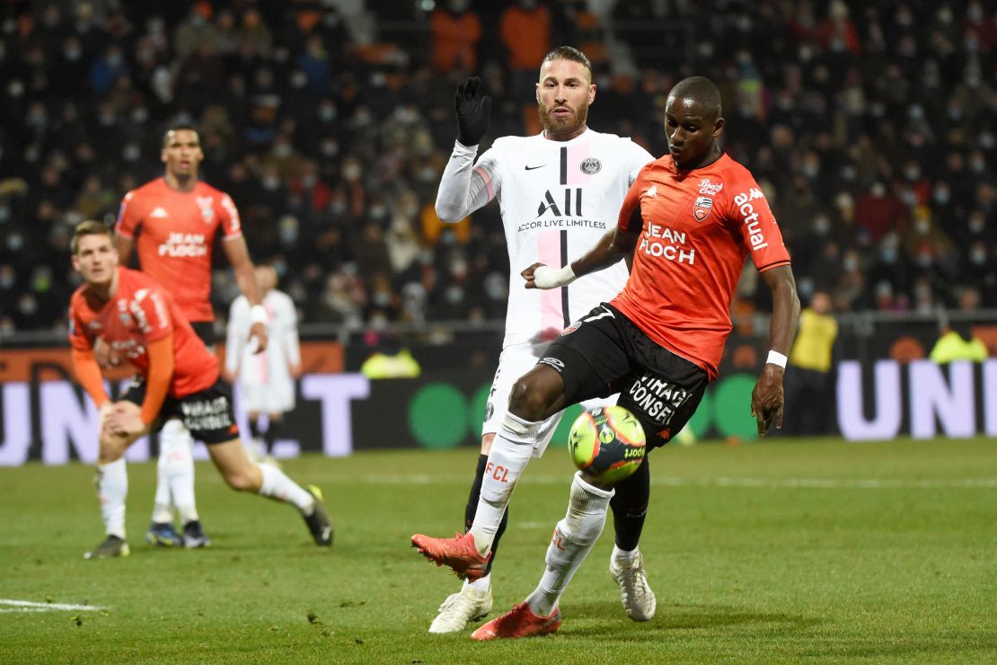 Lorient's French defender Houboulang Mendes (R) fights for the ball with Paris Saint-Germain's Spanish defender Sergio Ramos (C). Later in the game Ramos was sent off for the 27th time in his career.