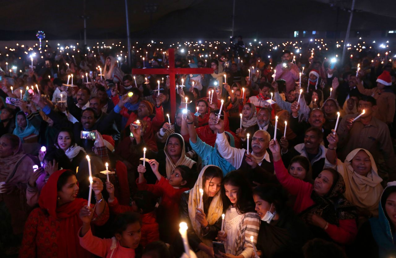 Christians hold candles during a Christmas celebration in Lahore, Pakistan, on December 22.