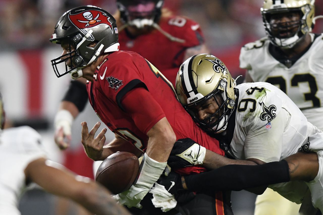 Tampa Bay Buccaneers quarterback Tom Brady fumbles after getting hit by New Orleans Saints defensive end Cameron Jordan during the Saints' 9-0 victory December 19 in Tampa.