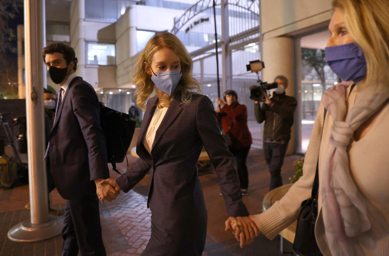Theranos founder and former CEO Elizabeth Holmes, center, walks with her partner Billy Evans and mother Noel Holmes as they leave court December 17 in San Jose, California. Jury deliberations have begun in <a href="https://www.cnn.com/2021/12/19/tech/elizabeth-holmes-trial-what-to-know/index.html" target="_blank">Elizabeth Holmes' fraud trial.</a> She is facing charges of conspiracy and wire fraud for allegedly engaging in a multimillion-dollar scheme to defraud investors.