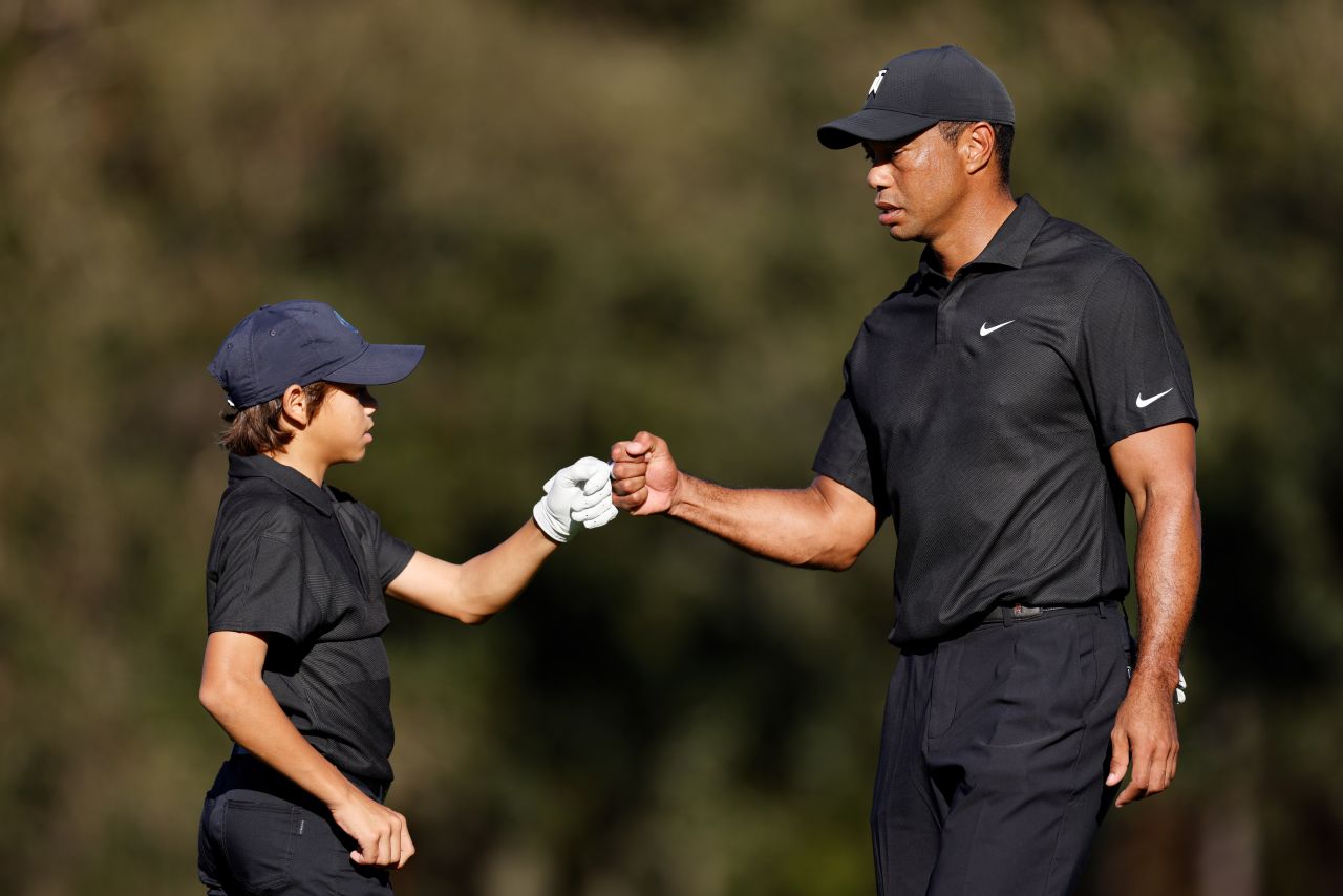 Tiger Woods and his 12-year-old son, Charlie Woods, fist bump on the course ahead of <a href="https://www.cnn.com/2021/12/18/sport/tiger-woods-pnc-championship/index.html" target="_blank">the PNC Championship</a> in Orlando, Florida, on December 17. They finished second. It was Tiger Woods' first time competing on a golf course since a car crash that crushed his leg in February.