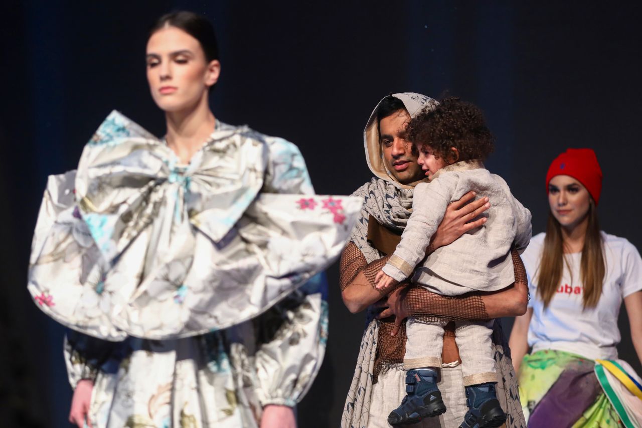 Models walk on the catwalk in Sarajevo, Bosnia, on December 16 during the presentation of a collection dubbed "No Nation Fashion," a migrant-made fashion project. During the show, migrant models came out in designs meant to symbolize various stages of their journeys.