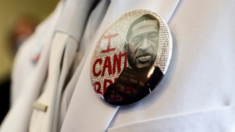 A button that reads "I can't breathe," adorns the jacket of a mourner before the funeral for George Floyd on Tuesday, June 9, 2020, in Houston.