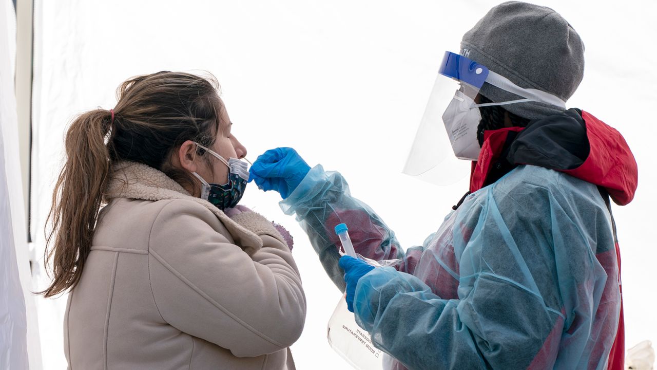 A woman is tested for COVID-19 at a walk-up testing site at Farragut Square on Thursday, Dec. 23, 2021, just blocks from the White House in Washington. (AP Photo/Jacquelyn Martin)