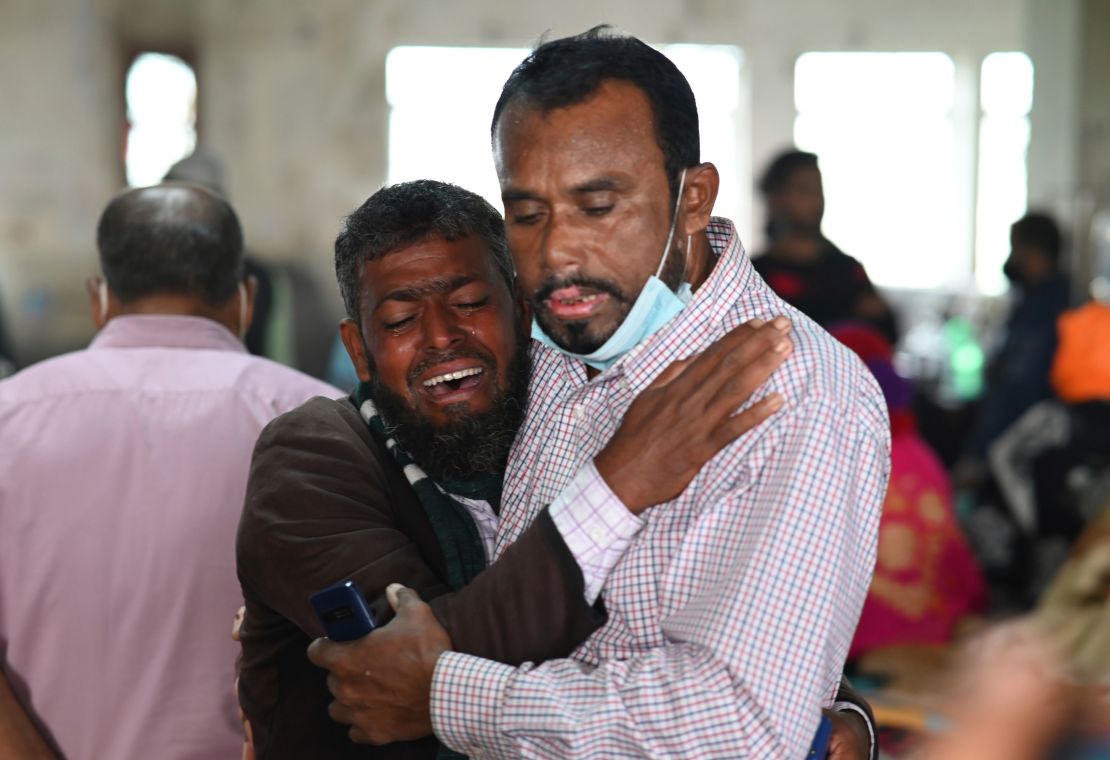 A man is consoled at a government hospital after a ferry caught fire in Khalakathi, Bangladesh on December 24.