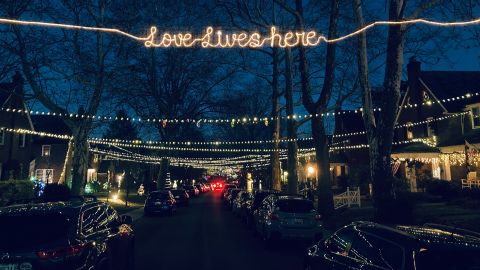Neighbors connect their holiday lights on Dunkirk Rd. in Towson, MD. The tradition started in 2020 with 32 houses joining in. 