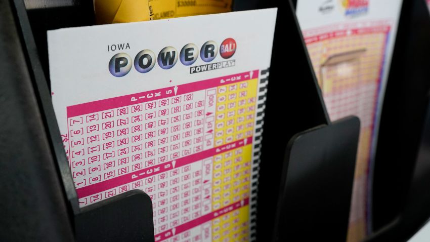 FILE - In this Jan. 12, 2021 file photo, blank forms for the Powerball lottery sit in a bin at a local grocery store, in Des Moines, Iowa. (AP Photo/Charlie Neibergall)