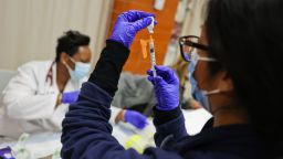 Freeport, N.Y.: Dr. Twana Jackson prepares pediatric doses of the Pfizer COVID-19 vaccine as the Mount Sinai South Nassau Vaxmobile vists Freeport High School in Freeport, New York on November 30, 2021. (Photo by Steve Pfost/Newsday RM via Getty Images)