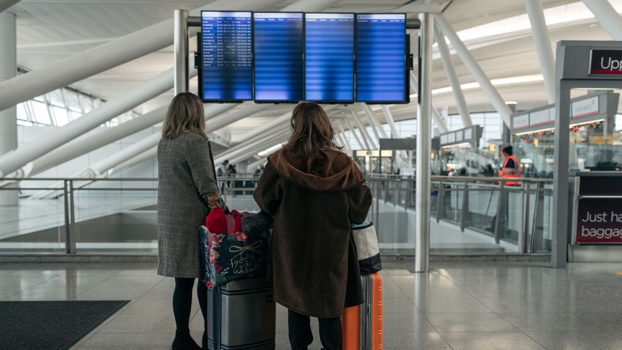 NEW YORK, NY - DECEMBER 24: Travelers move through the departures hall at Terminal 4 of John F. Kennedy International Airport on December 24, 2021 in New York City. Thousands of travelers were left stranded across the country after multiple airlines cancelled Christmas Eve flights Friday due to rising Omicron variant cases of COVID-19, staffing shortages and severe weather. (Photo by Scott Heins/Getty Images)