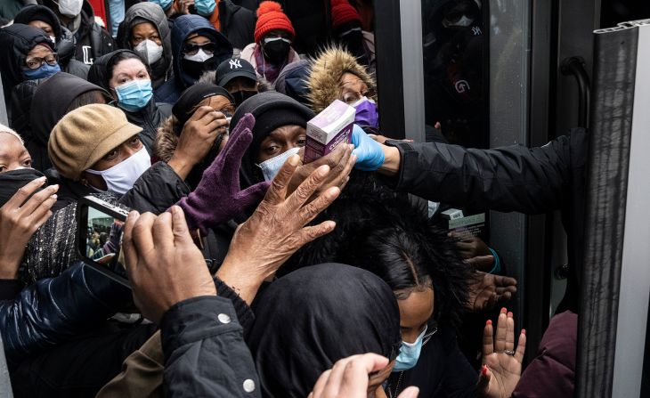 People scramble to get free Covid-19 test kits that were distributed by the city in Brooklyn, New York, on Friday, December 24. With coronavirus cases surging during the holidays, frustrated Americans <a  target="_blank">have been struggling to get tested.</a>