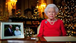 WINDSOR, ENGLAND - DECEMBER 23: Queen Elizabeth II records her annual Christmas broadcast in the White Drawing Room at Windsor Castle on December 23, 2021 in Windsor, England. The photograph on the desk is of The Queen and the Duke of Edinburgh, taken in 2007 at Broadlands, Hampshire, to mark their Diamond Wedding Anniversary. (Photo by Victoria Jones - Pool/Getty Images)