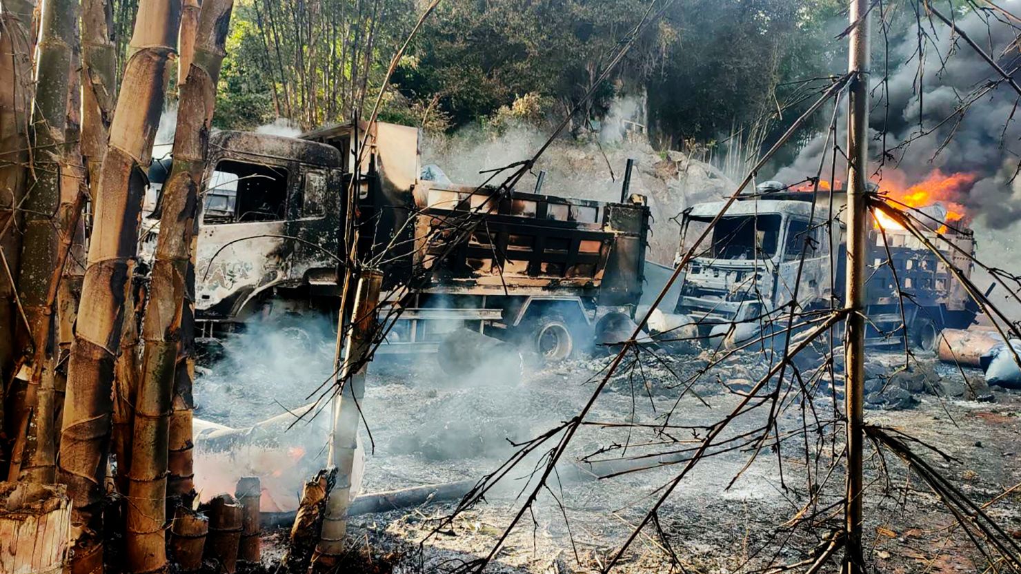 Smoke and flames rise from burnt out vehicles in Hpruso township, Myanmar, on December 24.