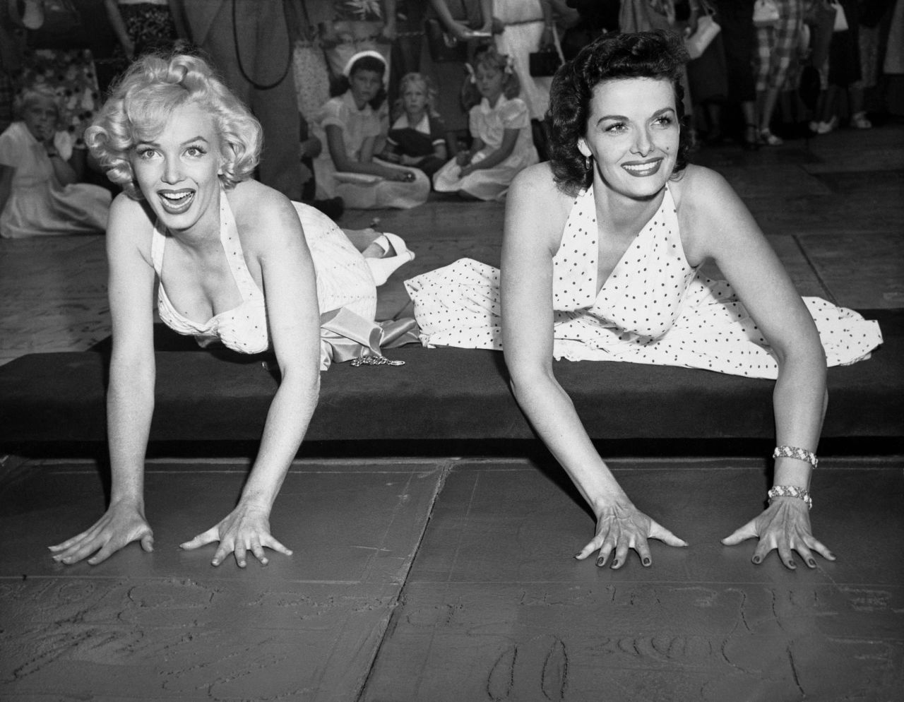 Monroe and "Gentlemen Prefer Blondes" co-star Jane Russell place their hands in cement at Grauman's Chinese Theatre. The musical comedy topped the box office in 1953.