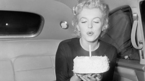 Monroe blows out the candle on 30th birthday cake. 