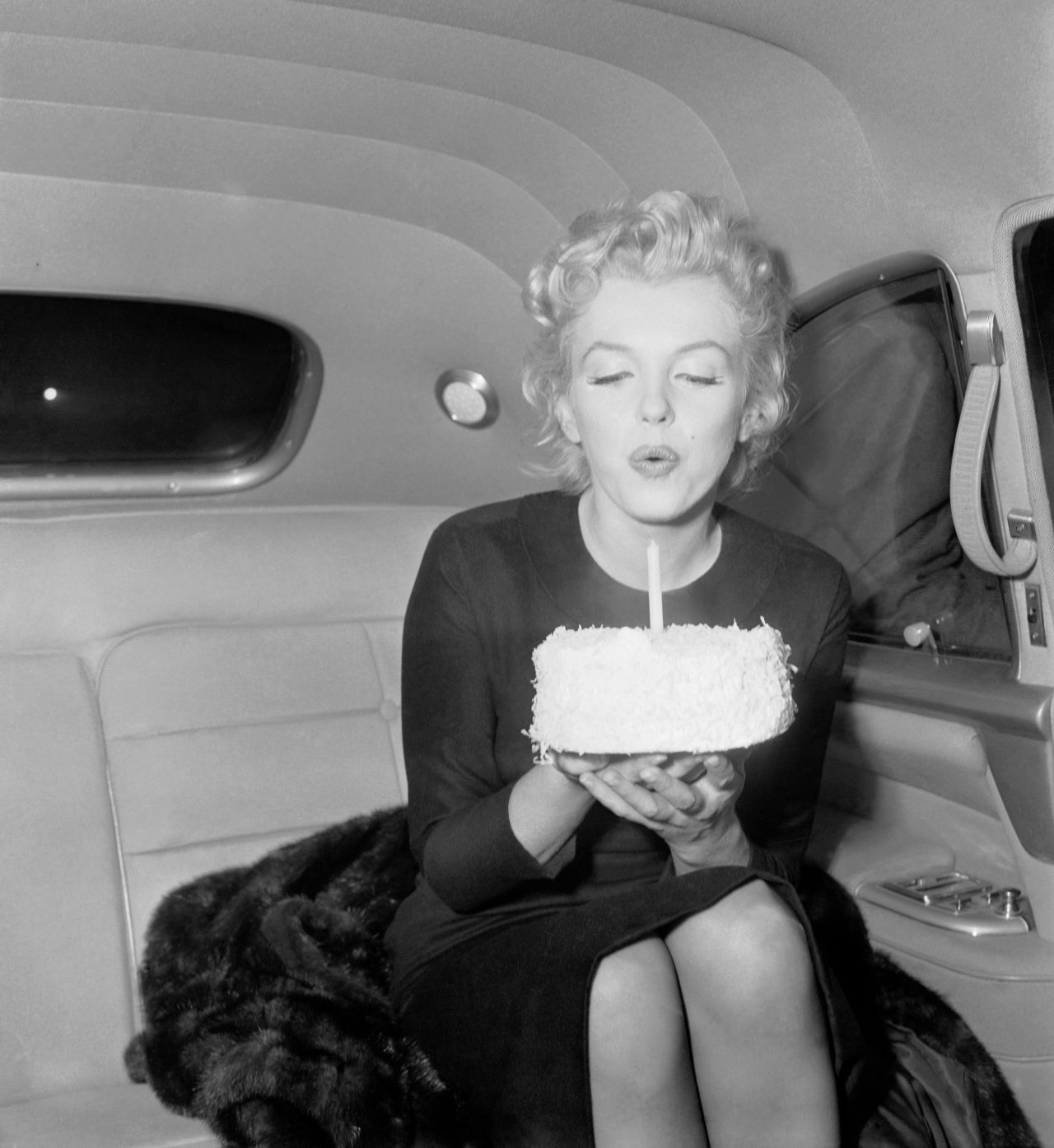 Monroe blows out the candle on 30th birthday cake. 