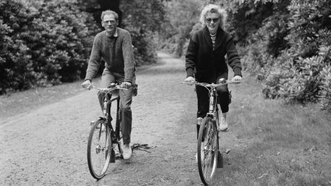 Monroe rides her bike with her third husband Miller. He's best known for writing the play Death of a Salesman.