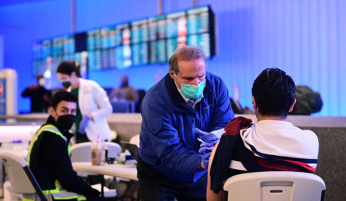 The Covid-19 vaccine is administered at a pop-up clinic in the international arrivals section of Los Angeles International Airport in Los Angeles, California, on December 22, 2021.