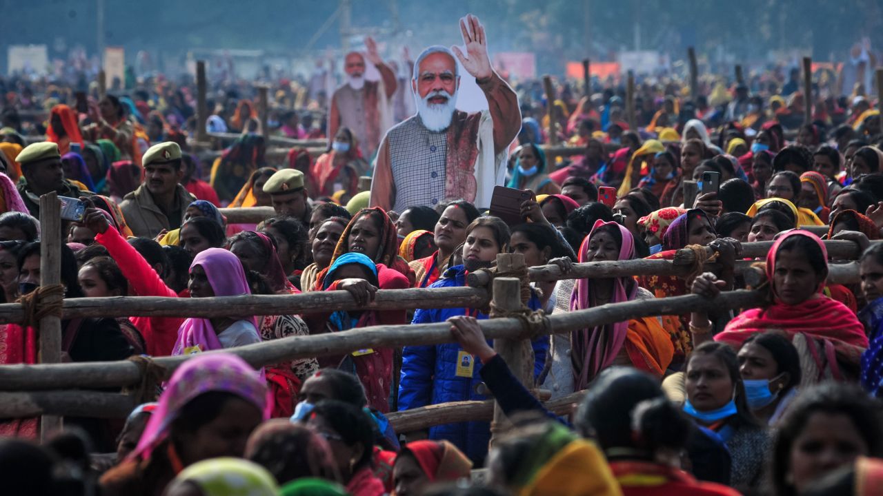 ALLAHABAD, INDIA - DECEMBER 21: Women from various districts are seen near cut-outs of India's Prime Minister Narendra Modi at a rally held by Modi on December 21, 2021 in Allahabad, India. Modi visited the governing Bharatiya Janata Party (BJP)'s strongholds in Uttar Pradesh, as India's economy emerges from Covid-19 and against the backdrop of sectarian tensions within the country increasing. Modi held the rallies as part of his "Vision of Prime Minister to empower the women" campaign in which the campaign transfers money to the accounts of self-help groups, benefiting around 1.6 million women members of the groups, local media said. (Photo by Ritesh Shukla/Getty Images)