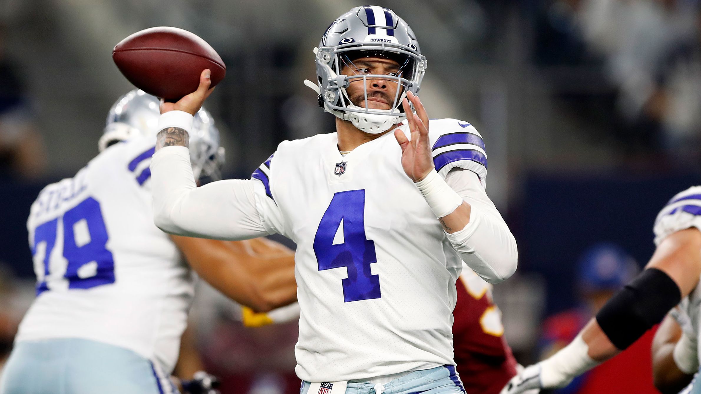 Dak Prescott #4 of the Dallas Cowboys throws a pass during the first half against the Washington Football Team at the AT&T Stadium on December 26, 2021 in Arlington, Texas.