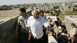 Nobel peace laureate Desmond Tutu (C) visits a house in the town of Beit Hanun in the northern Gaza Strip on May 28, 2008. UN human rights observers led by Tutu met today survivors of a 2006 Israeli bombing that killed 19 Palestinian civilians in Gaza, leading the South African cleric to say the group was "devastated" by what they learned. The UN team travelled to the town of Beit Hanun where residents told of the Israeli shelling on the night of November 8, 2006, that killed the civilians, including five women and eight children, in their homes. 
