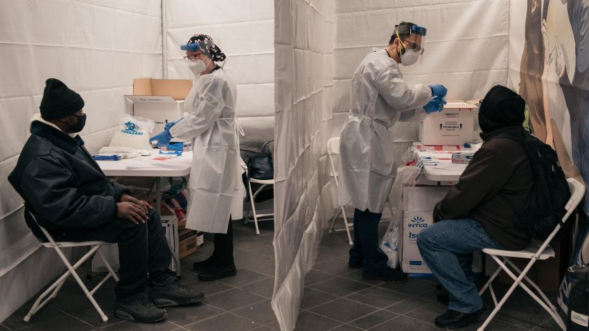Medical workers prepare COVID-19 tests at a new testing site inside the Times Square subway station on December 27, 2021 in New York City.