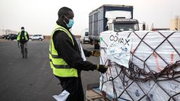 Workers start to un-wrap boxes containing Oxford/AstraZeneca vaccines donated to Senegal by the Covax global Covid-19 vaccination program are seen as they are unloaded in Dakar on March 3, 2021. 