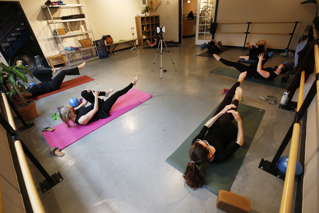 Martina Knight instructs a smaller barre class, with participants observing social distancing, at the SLO Yoga Center in San Luis Obispo, California, on March 3, 2021.
